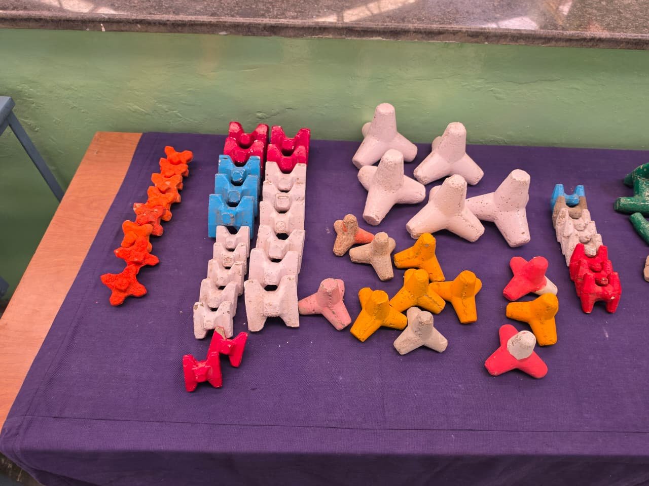 Assorted coloured scale-model coastal armour units arranged for testing
