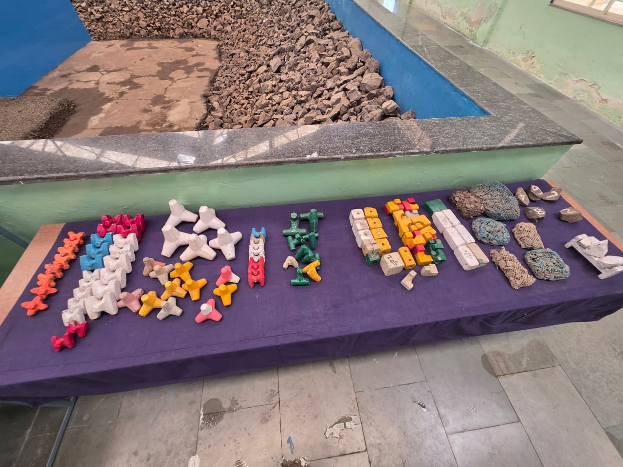 Multiple coastal protection unit forms arranged beside a laboratory flume